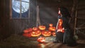 Halloween. child little witch with pumpkin by the window waitin Royalty Free Stock Photo