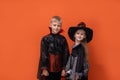 Halloween children on white background. Kids in vampire and witch costume. Happy Halloween. boy is holding smartphone Royalty Free Stock Photo