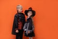 Halloween children on white background. Kids in vampire and witch costume. Happy Halloween. boy is holding smartphone Royalty Free Stock Photo