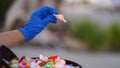 Halloween 2020: close-up of a gloved hand giving out candy to a young girl in a costume