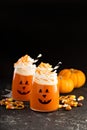 Halloween cold cocktail or drink with jack o`lantern face