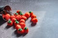 Halloween-colored pumpkin-shaped candy canes are placed on a gray table with sunlight in the background Royalty Free Stock Photo