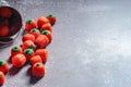 Halloween-colored pumpkin-shaped candy canes are placed on a gray table with sunlight in the background Royalty Free Stock Photo