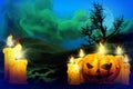 Halloween colorful horror night mockup - set of candles on left and candle in pumpkin style on the right, trick or treat concept Royalty Free Stock Photo