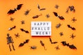 Halloween composition. Black skeletons, bats, spiders, flies, bugs and rats on orange background. Text HAPPY HALLOWEEN, trick or Royalty Free Stock Photo
