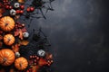 Halloween composition with copy space, postcard with pumpkins, spiders, cobwebs and autumn leaves on a concrete background