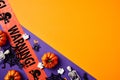 Halloween composition. Flat lay warning tape, pumpkins, Halloween decorations on split orange and violet background