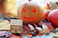 Halloween composition of jack o` lantern, pumpkins, illumination, mystical decor