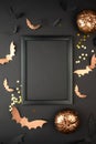 Halloween composition mock up. Black photo frame, flying black paper bats on purple background. Royalty Free Stock Photo