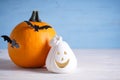 Halloween composition, pumpkins and bats on wooden background, space for text