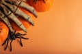 Halloween composition with pumpkins, monster hand, spiders on orange background. Happy halloween banner mockup Royalty Free Stock Photo