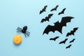 Halloween composition. Spider, pumpkin and bats on a pastel blue background. Top view, flat lay. Royalty Free Stock Photo