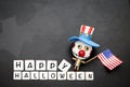 Halloween concept background of funny bozo wooden ghost with American flag