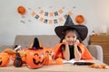 Halloween concept cute little child girl preparing to celebrate at home Royalty Free Stock Photo