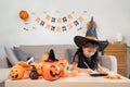 Halloween concept cute little child girl preparing to celebrate at home Royalty Free Stock Photo