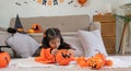 Halloween concept cute little child girl preparing to celebrate at home Royalty Free Stock Photo