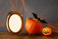 Halloween concept. Cute pumpkin next to blank photo frame Royalty Free Stock Photo