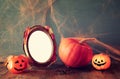 Halloween concept. Cute pumpkin next to blank photo frame Royalty Free Stock Photo