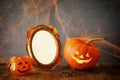 Halloween concept. Cute pumpkins next to blank photo frame Royalty Free Stock Photo