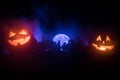 Halloween concept with glowing pumpkins. Strange silhouette in a dark spooky forest at night, mystical landscape surreal lights wi Royalty Free Stock Photo