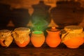 Halloween concept greeting card of clay pots with green mystical Royalty Free Stock Photo