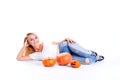 Halloween concept, happy Girl lies on floor with pumpkins preparing for holiday, with Jack lantern, funny and spooky pumpkin.