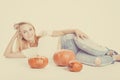 Halloween concept, happy Girl lies on floor with pumpkins preparing for holiday, with Jack lantern, funny and spooky pumpkin.