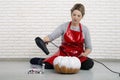 A woman artist prepares for halloween and paints pumpkins Royalty Free Stock Photo