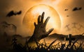 Halloween Concept Horror, night with resurrected zombie hands popping out of hell With moon floating in sky, atmosphere in cold Royalty Free Stock Photo