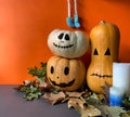 Halloween concept with jack o lantern pumpkins, autumn leaves, candles and character legs