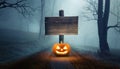 Halloween concept with Jack o Lantern and wooden road sign in the spooky forest Royalty Free Stock Photo