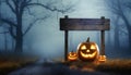 Halloween concept with Jack o Lanterns and wooden road sign in the spooky forest Royalty Free Stock Photo