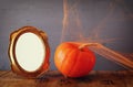 Halloween concept. pumpkin next to blank photo frame Royalty Free Stock Photo