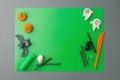 Halloween concept. symbols and decorations made of polymer clay on green table flat lay top view, copy space, creative seasonal