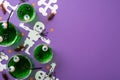 Halloween concept. Top view photo of glasses with green floating eyes punch skeleton silhouettes spiders centipedes cockroaches Royalty Free Stock Photo