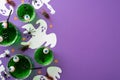 Halloween concept. Top view photo of green floating eyes punch skeleton ghost silhouettes spiders centipedes cockroaches and Royalty Free Stock Photo