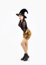 Halloween concept, young asian woman in black costume witch hat and boots for celebrate halloween party posing on white background