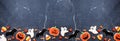 Halloween cookie bottom border on a dark stone banner background