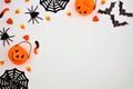 Halloween corner border of candy and decor, flat lay over white Royalty Free Stock Photo
