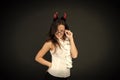 Halloween corporate party. Party girl celebrate Halloween dark background. Sexy woman wear red devil horns for halloween Royalty Free Stock Photo