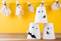 Halloween crafts paper cup ghost on wood