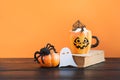 Halloween cup of coffee garnish spider web, spider, pumpkin. Holiday horror treat.