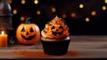 Halloween cupcake with color. Jack o\'lantern made with pumpkin. at a Halloween party, dessert. Muffin adorned with frosting,