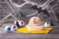 Halloween cupcake on the table decorated with bat and eyes