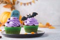 Halloween cupcakes with gingerbread cookies: tombstone and bat