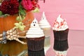 Halloween cupcakes. Spooky ghost bloody cupcakes. Halloween treats on pink wood background.