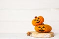 Halloween cute orange handmade felt pumpkins on an old white wooden background with copy space. Halloween kids craft background.