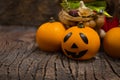 Halloween dark card. Three orange pumpkins. One of them is Jack. Bascet with garlic, berry, money, flower Royalty Free Stock Photo