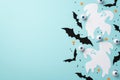 Halloween decor concept. Top view photo of ghost bat silhouettes spooky eyeballs and confetti on isolated light blue background
