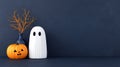 Halloween decor featuring a ghost pumpkin and branch against a dark background Royalty Free Stock Photo